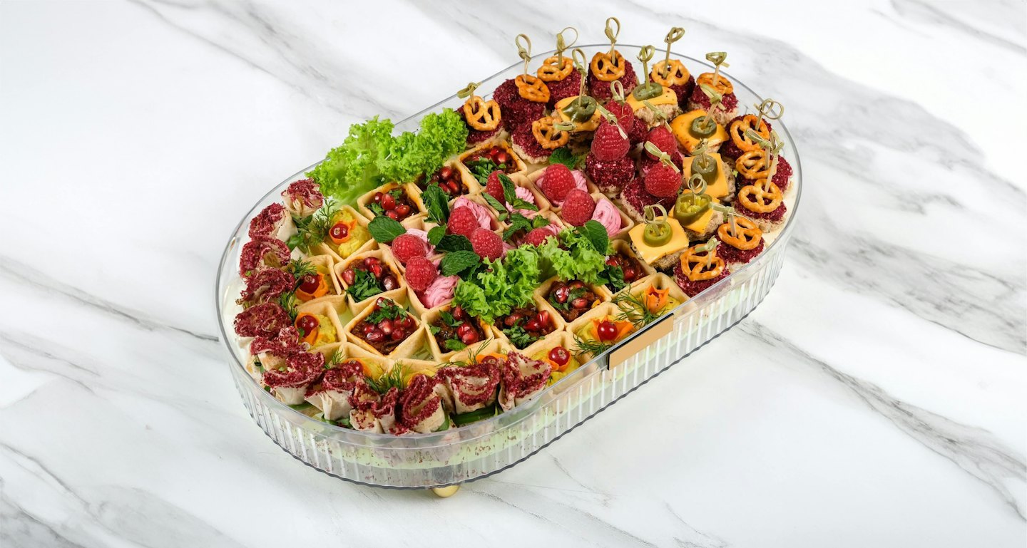 A tray of gourmet appetizers arranged on a marble surface.